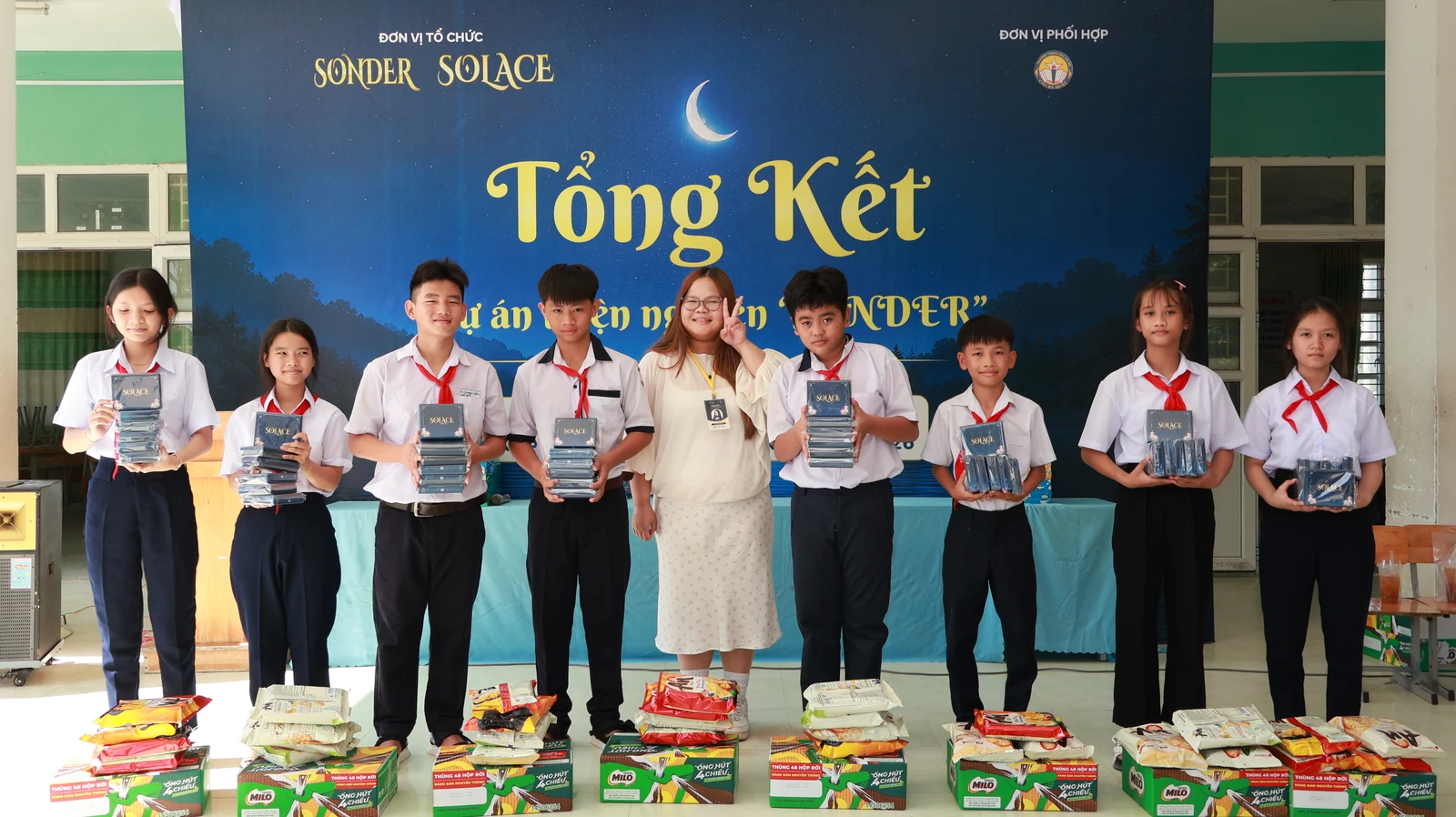 Hoàng Nhiên and students with SOLACE card decks and community gift packages